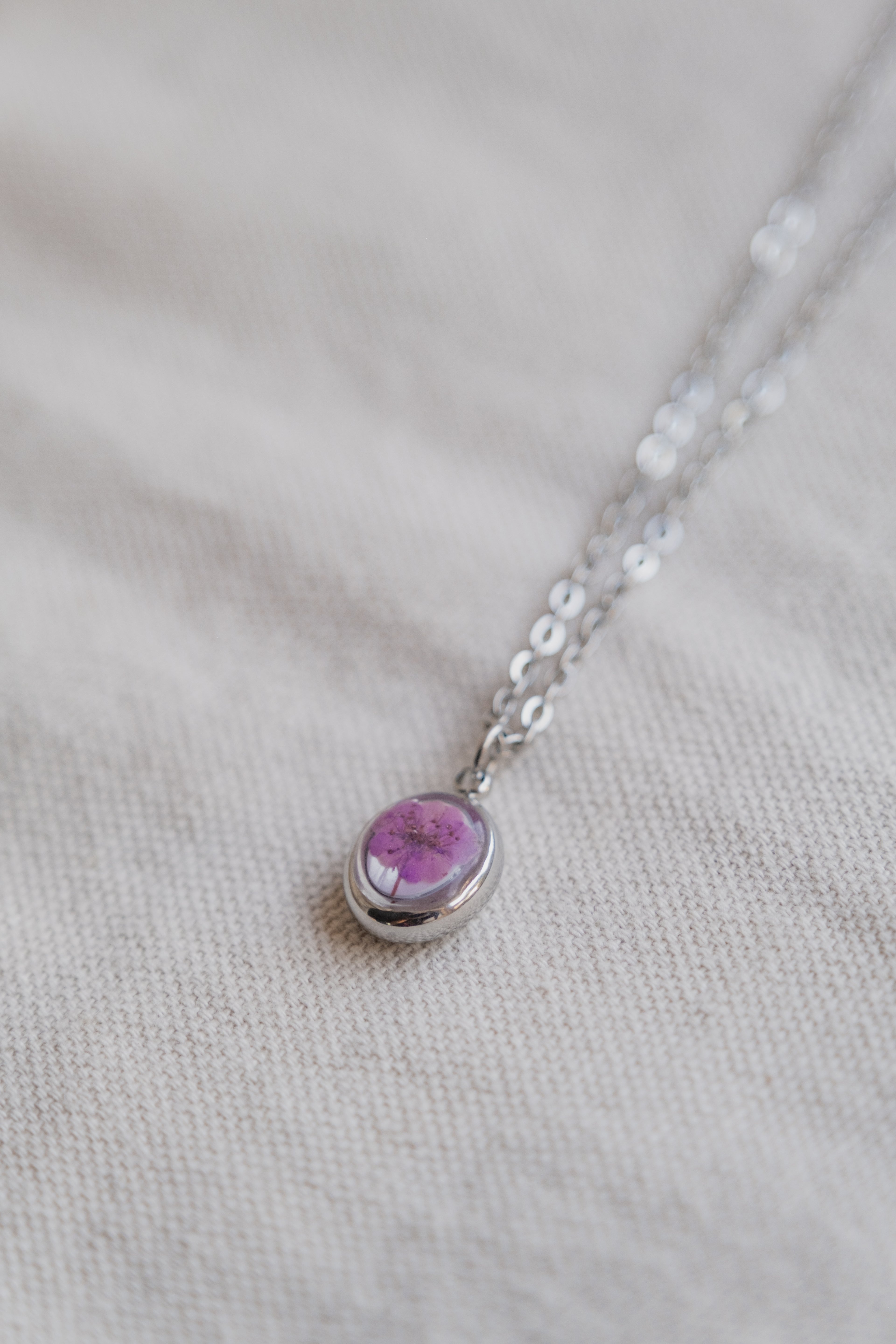 Collana ovetto con fondo in madreperla e narciso viola