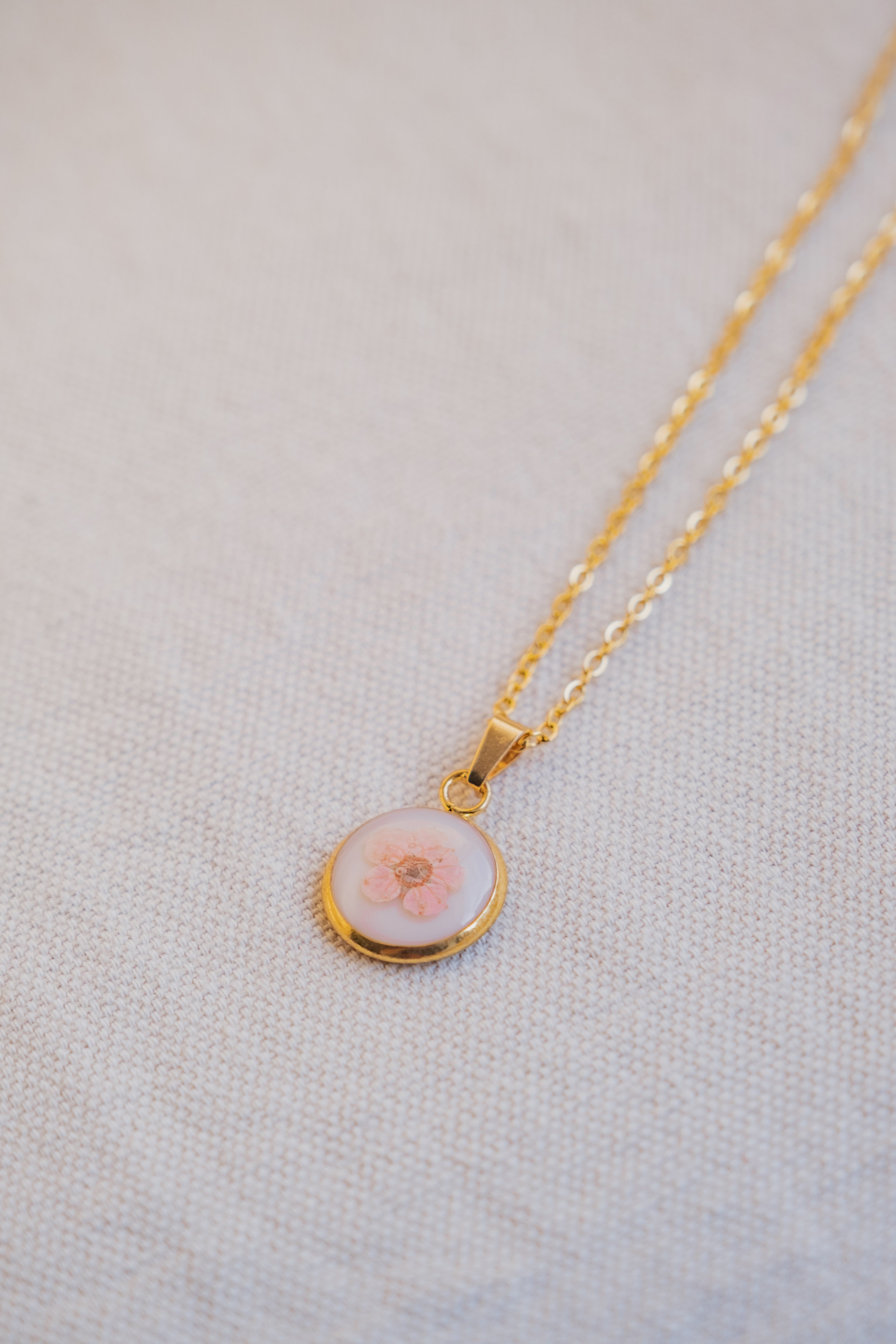 Collana fondo colorato con narciso rosa