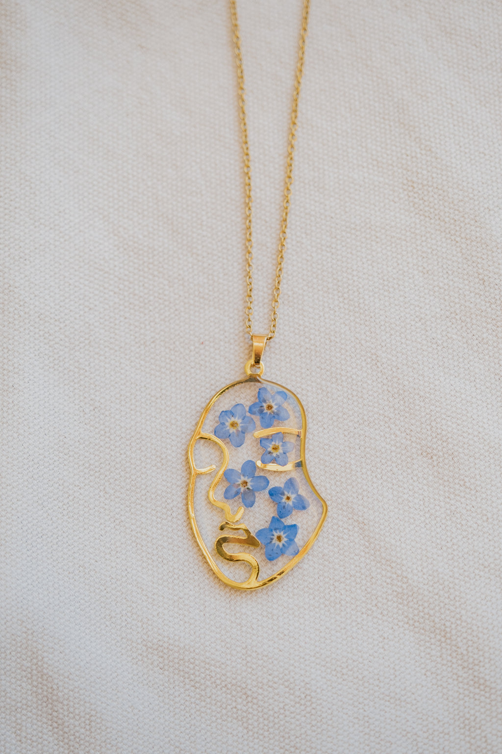 Collana "volto" con "Non ti scordar di me"