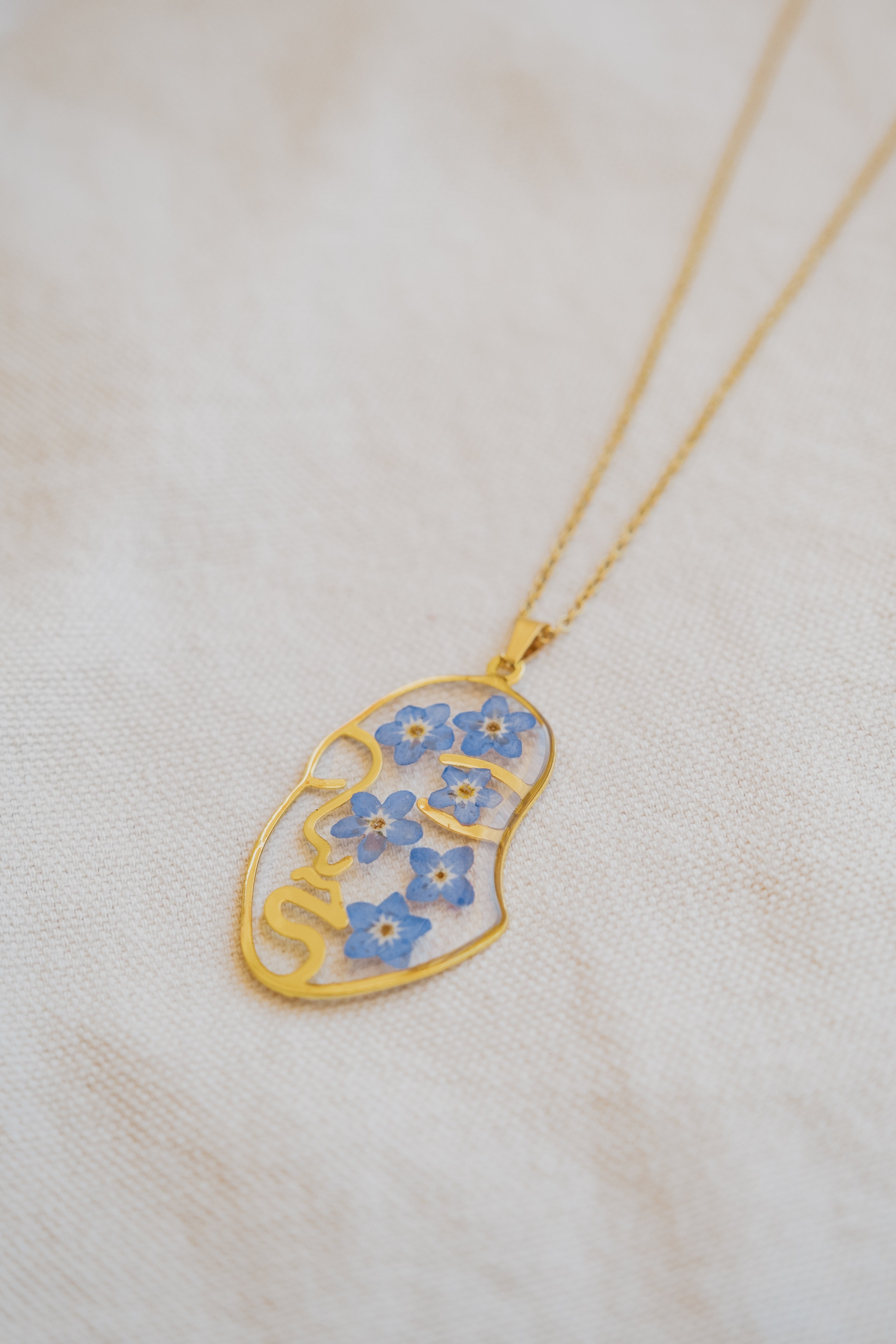 Collana "volto" con "Non ti scordar di me"
